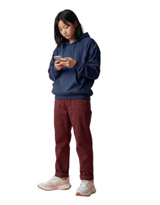 An image of a teen girl looking down at a mobile phone